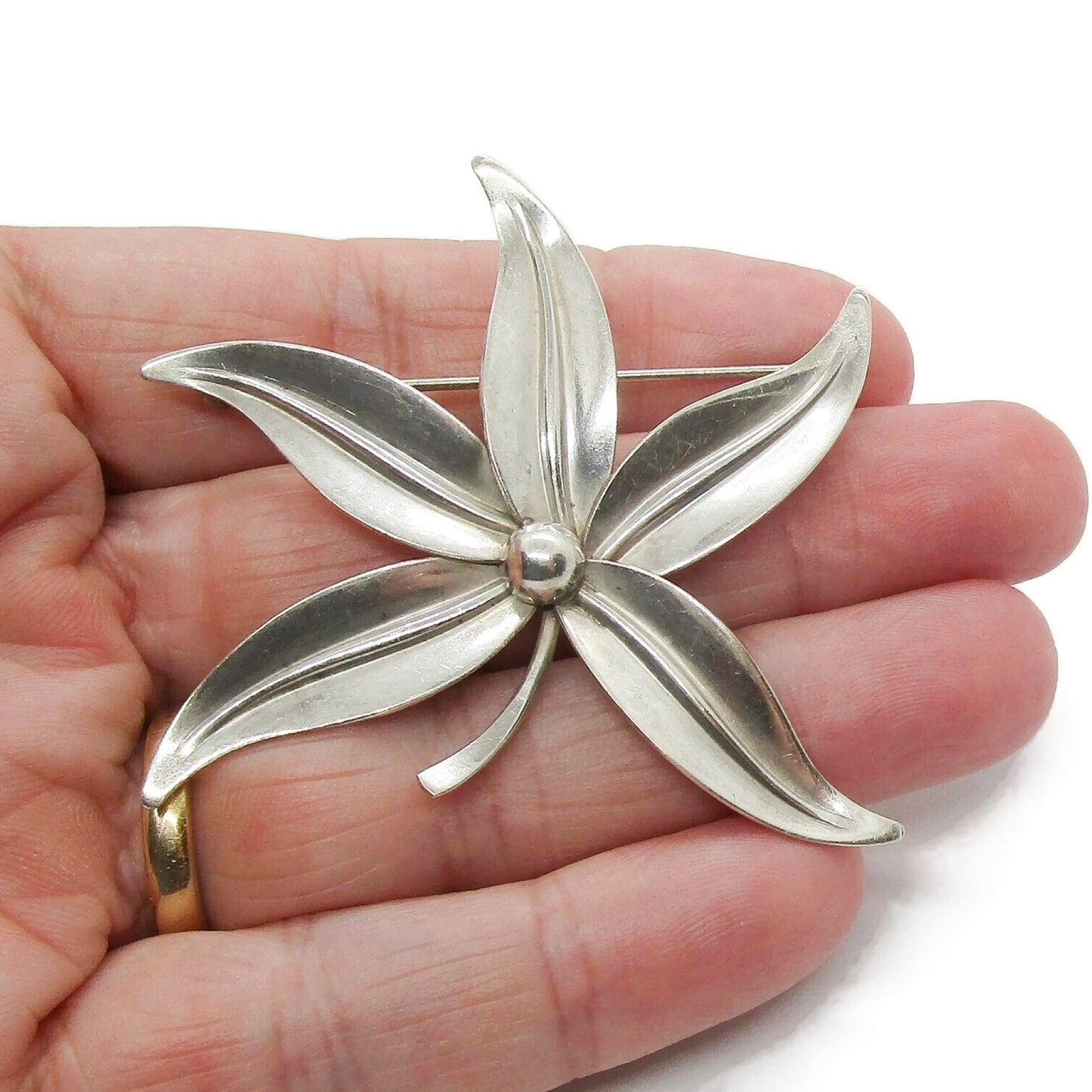 Large Niels Erik From sterling silver five leaf brooch shown held in the palm of a hand