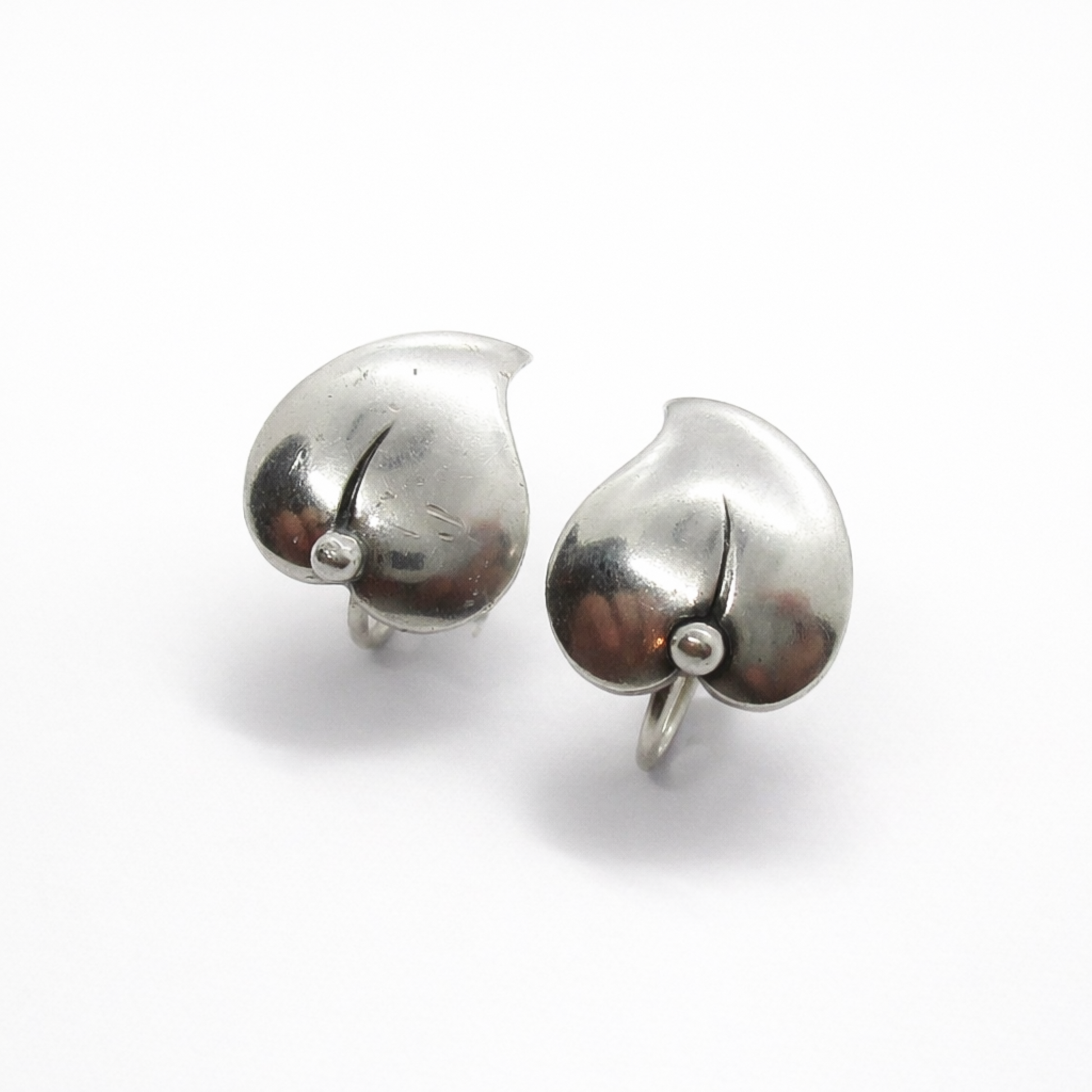 A pair of vintage sterling silver screw back leaf earring by Niels Erik From, Denmark shown on an angle