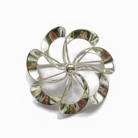 Front view of a Niels Erik From Denmark sterling silver pinwheel brooch