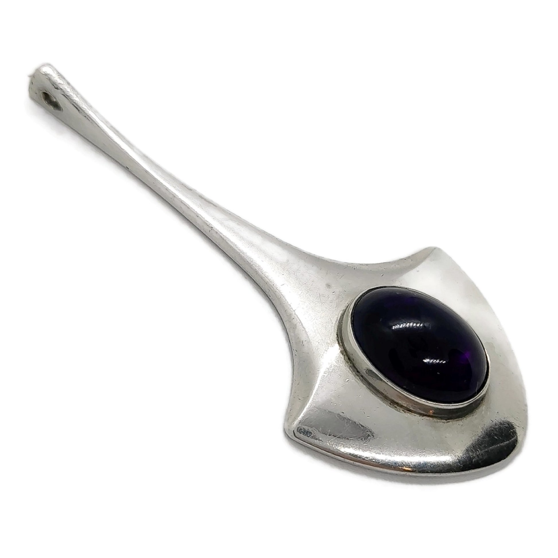 Angled view of a large vintage sterling silver and amethyst pendant