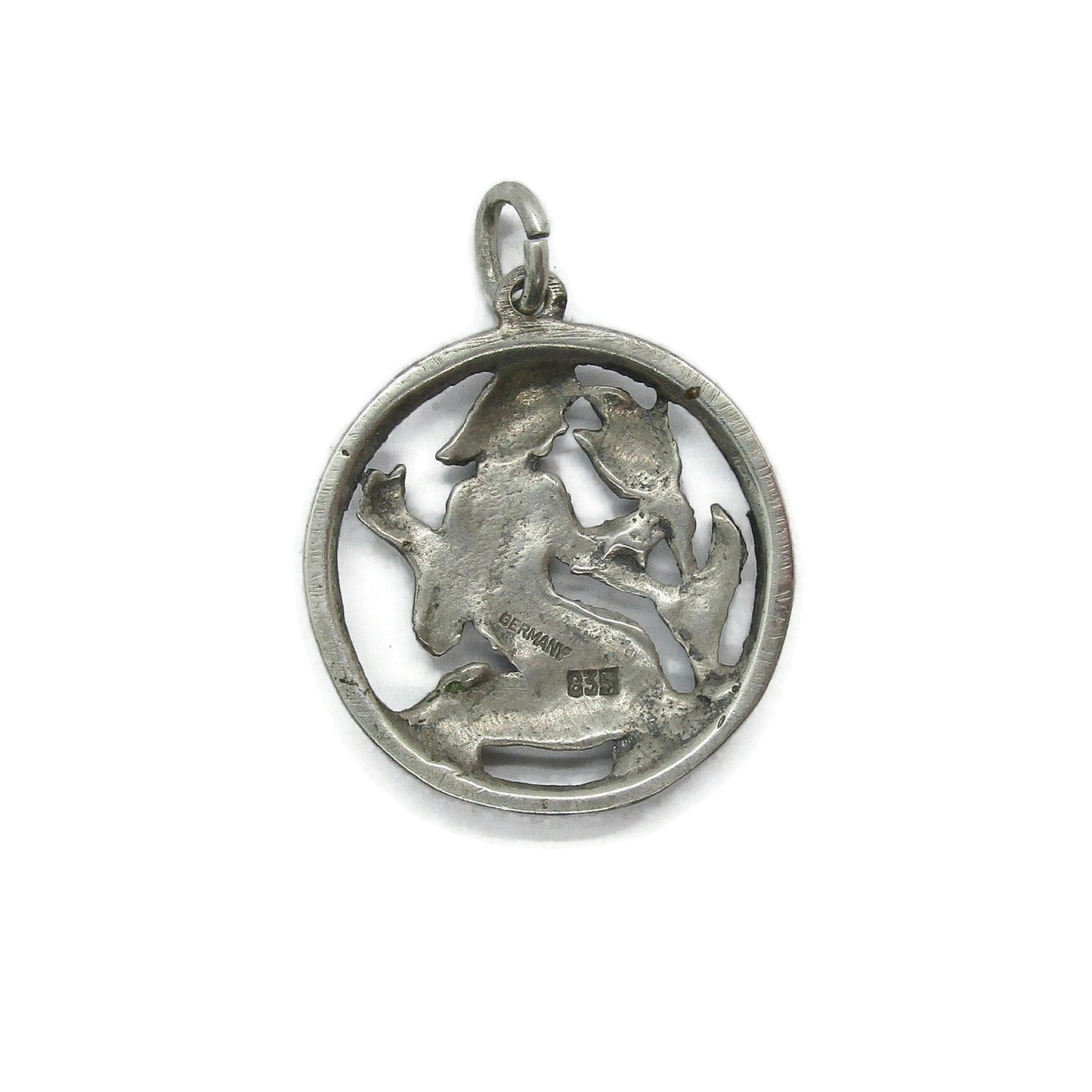 Back view of a vintage silver Virgo pendant