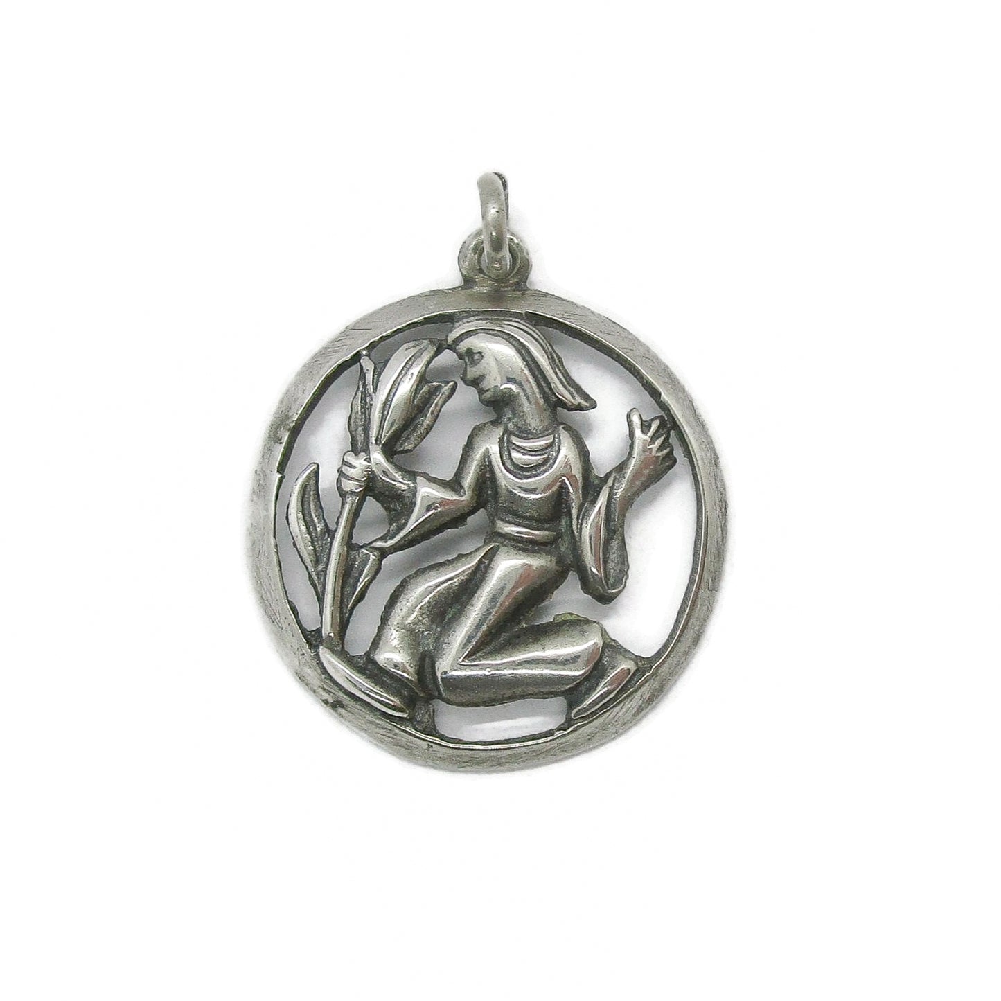 Front view of a vintage silver Virgo pendant