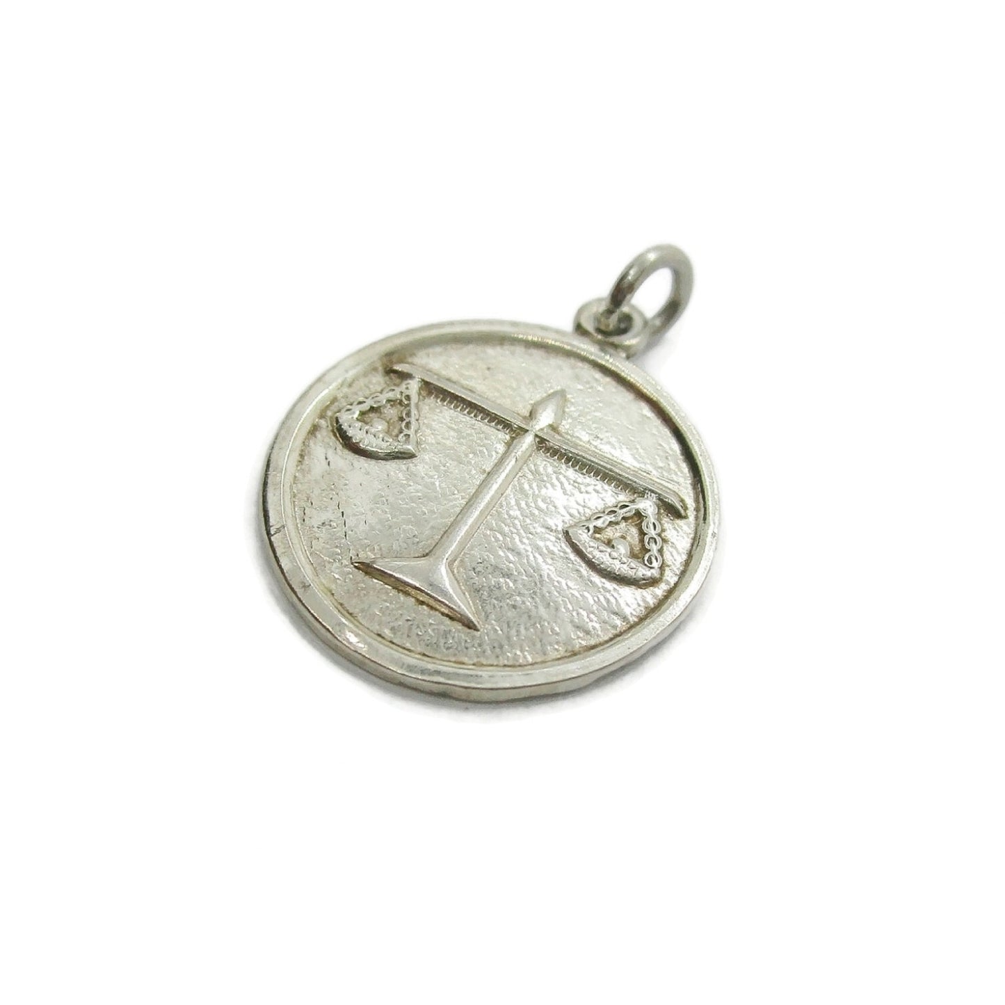 Silver Libra zodiac pendant on a white background