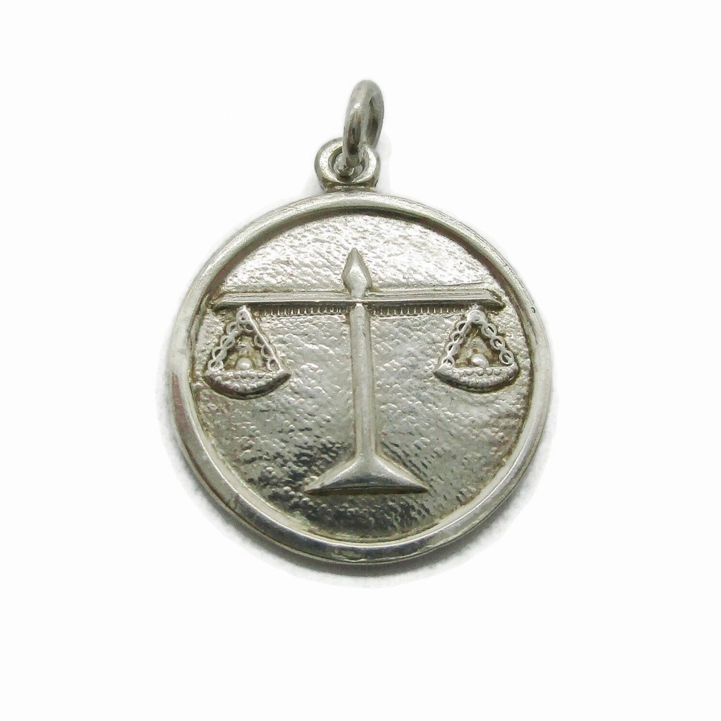 Front view of a small vintage sterling silver Libra pendant