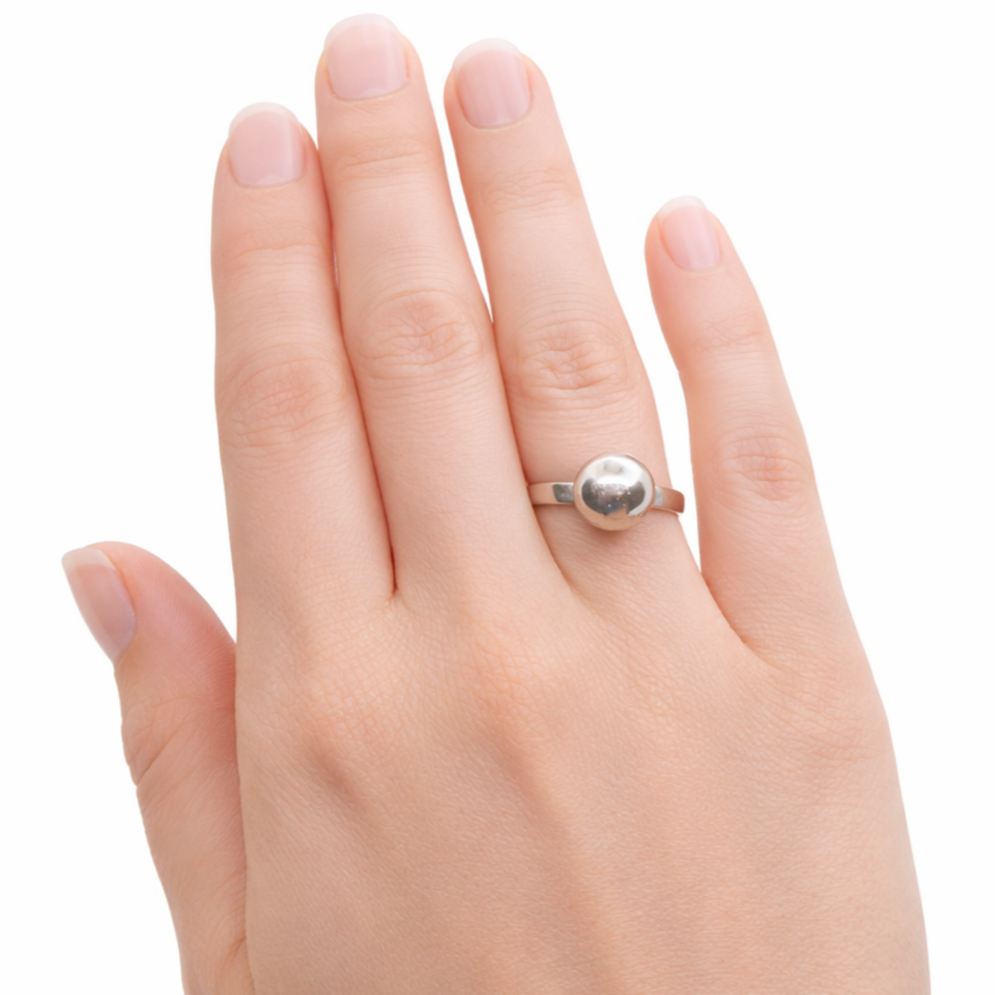 A sterling silver ball ring shown worn on a hand