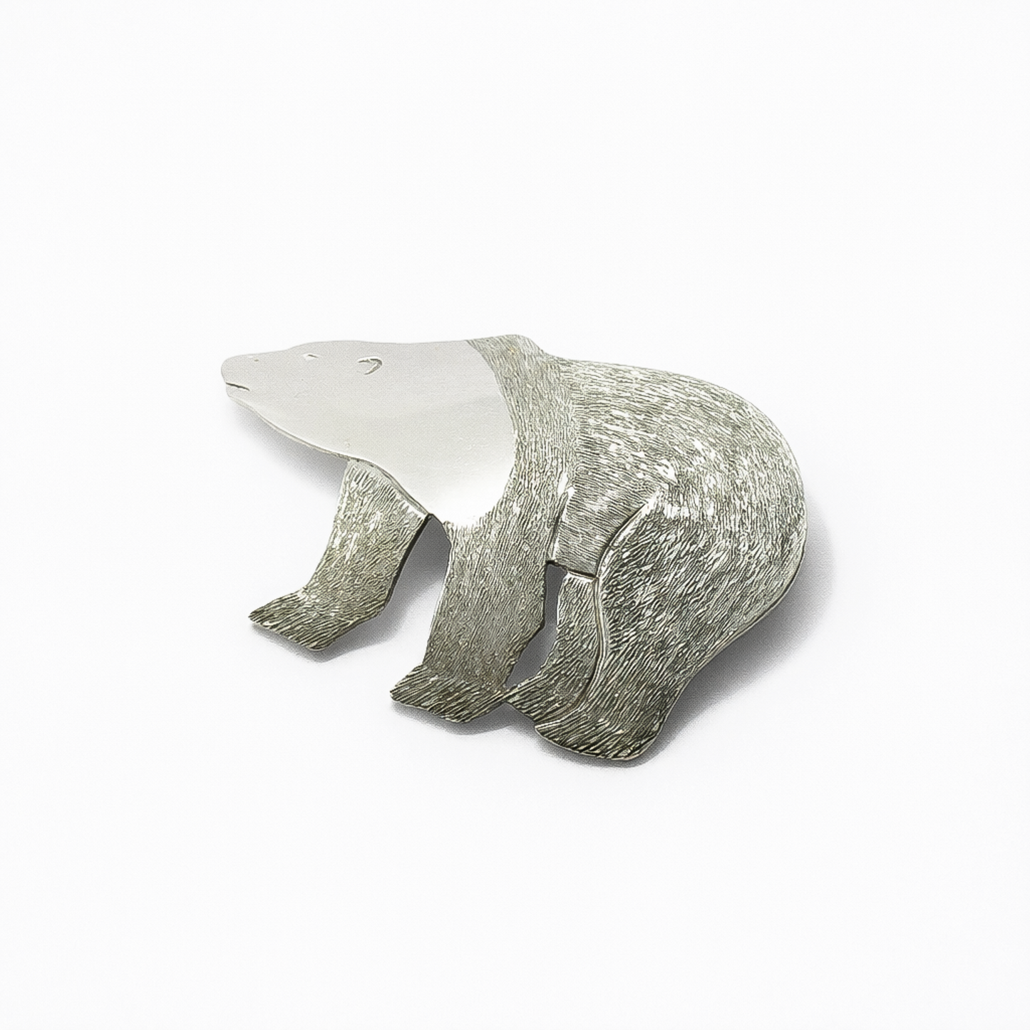 Angled view of a sterling silver polar bear brooch