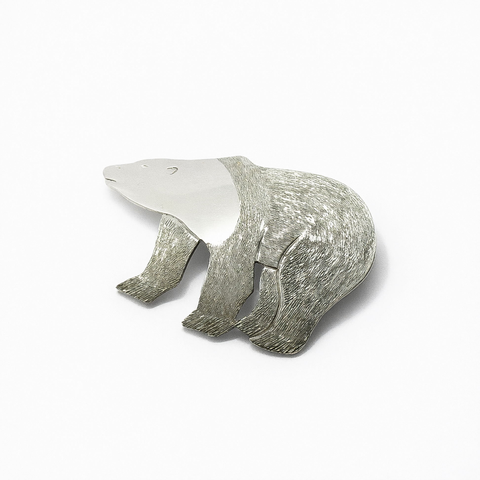 Angled view of a sterling silver polar bear brooch