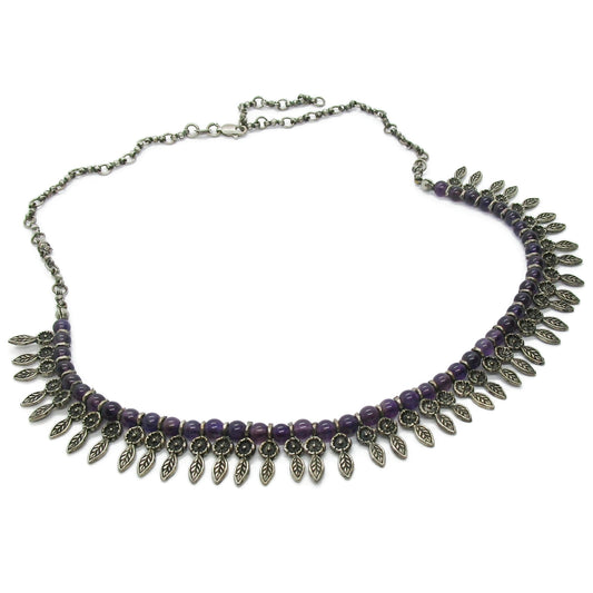 A vintage sterling silver and amethyst bead necklace on a white background