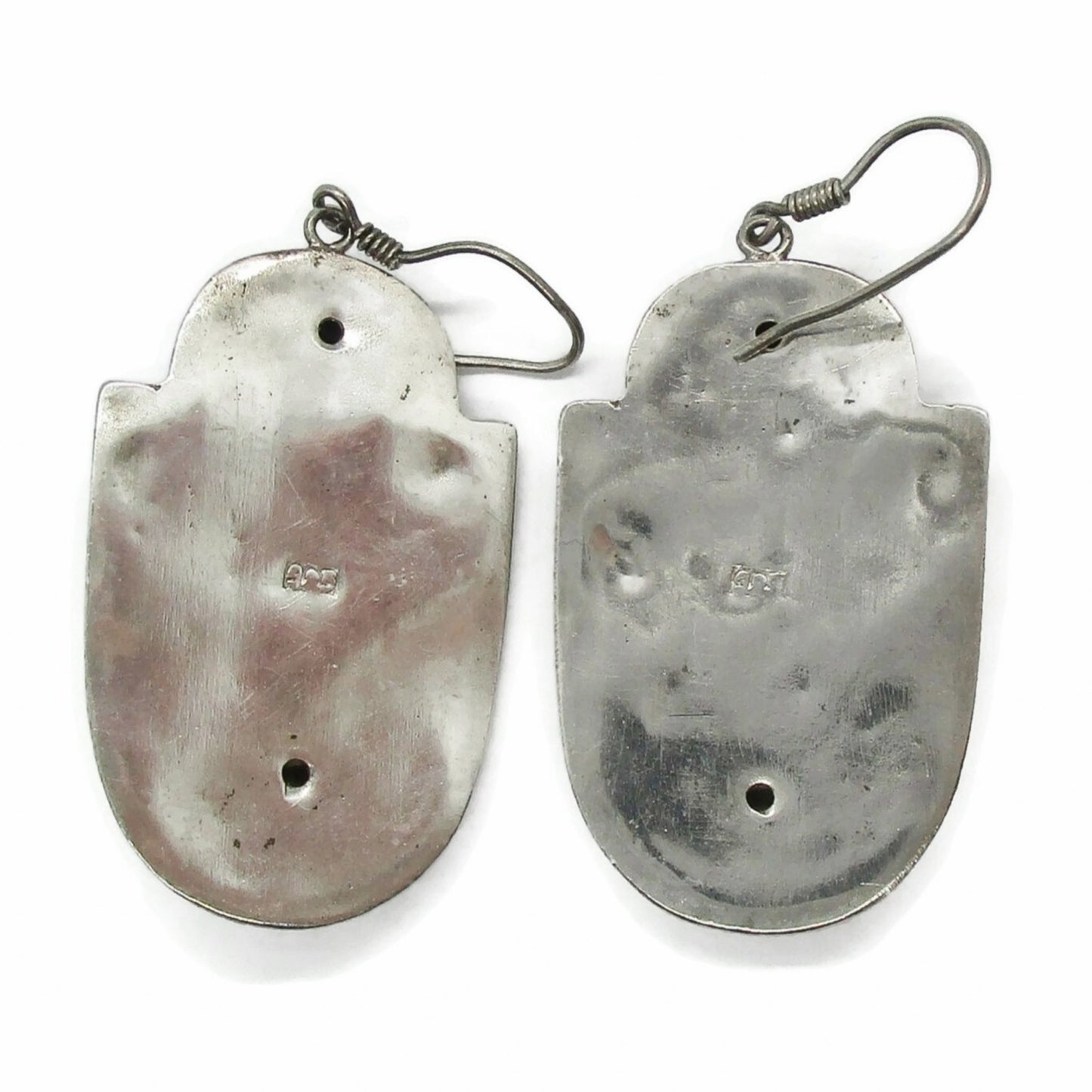 Back view of a pair of vintage big sterling silver face shaped dangle earrings