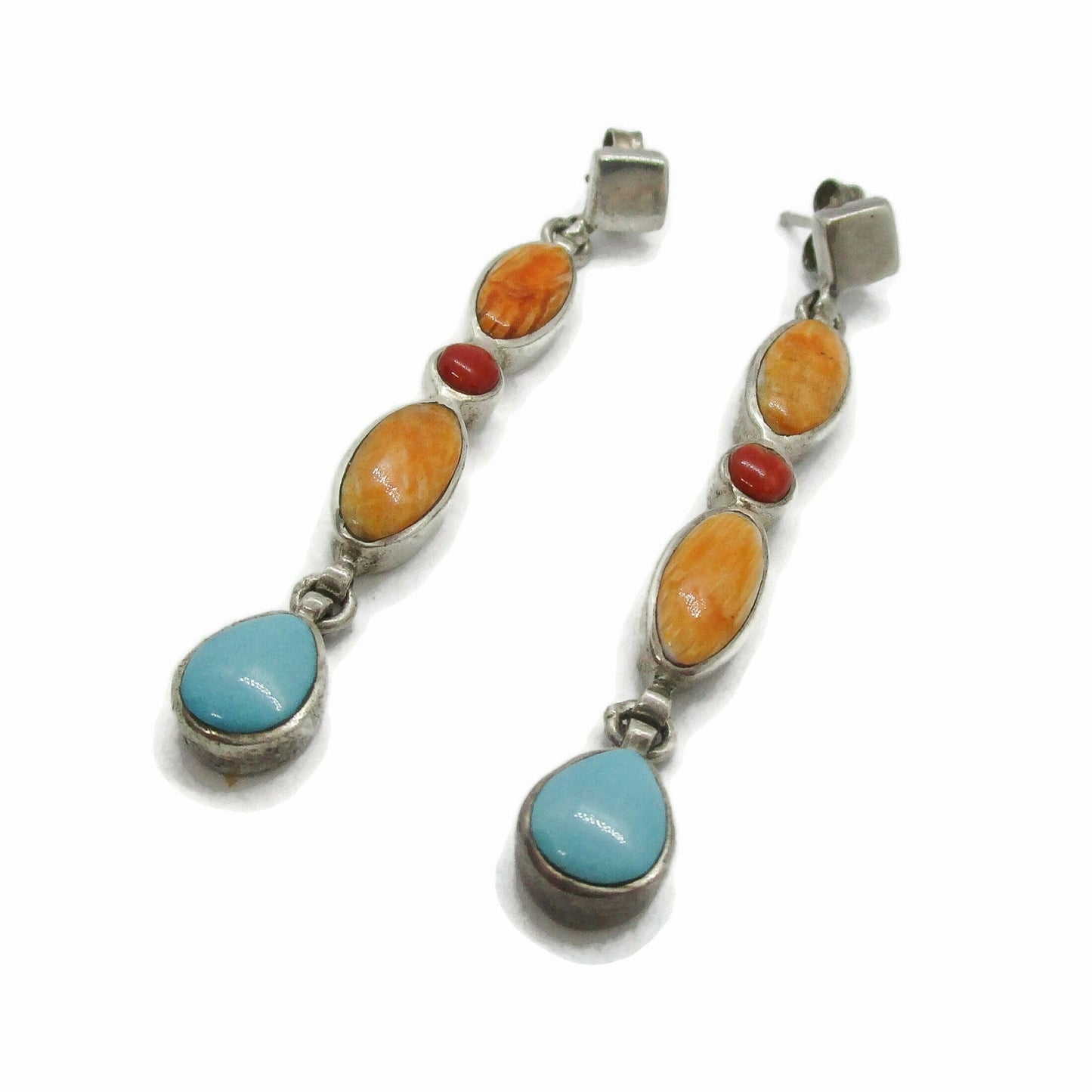 Angled view of a pair of sterling silver and semi precious gemstone dangle earrings