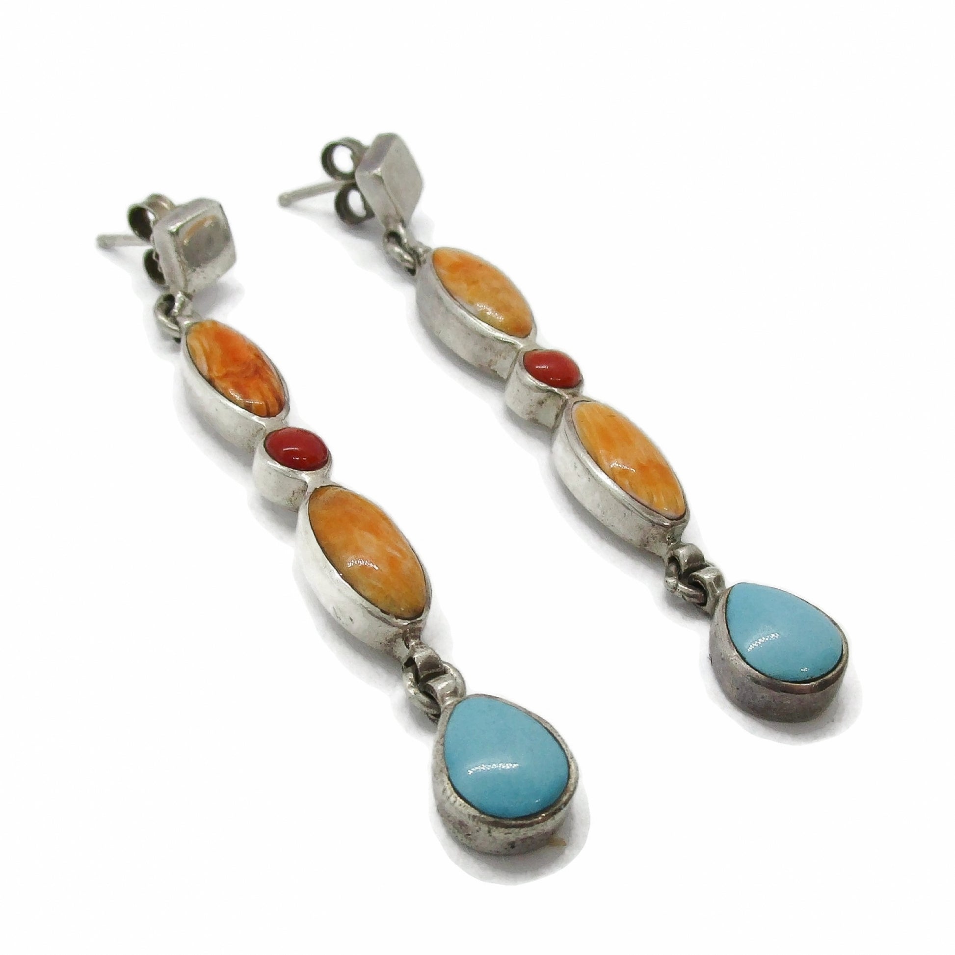Close up side view of a pair of sterling silver and semi precious gemstone dangle earrings