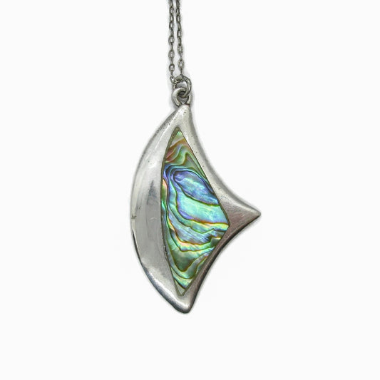 Front view of a vintage sterling silver and paua shell angular abstract pendant on a chain