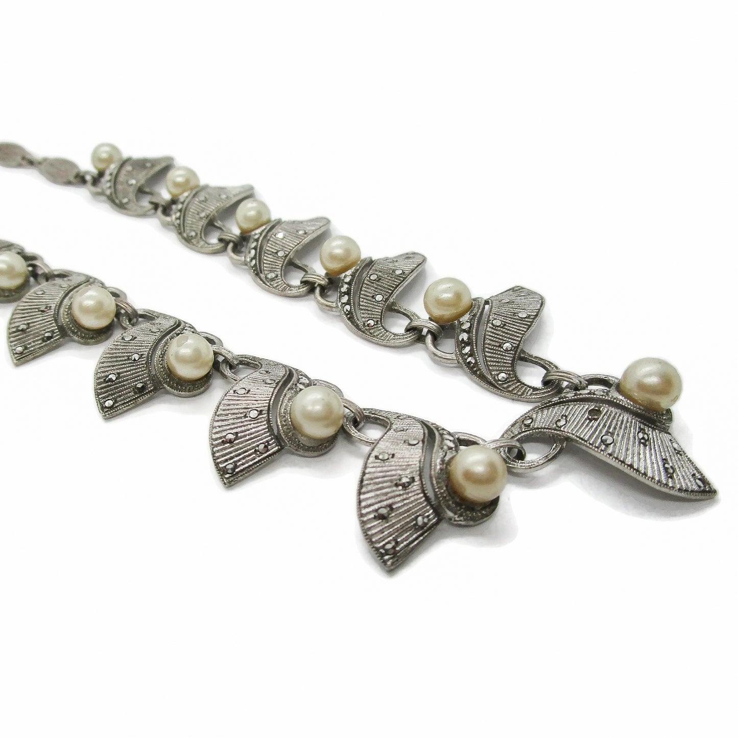 Close up angled view of a Theodor Fahrner sterling silver, marcasite and pearl necklace