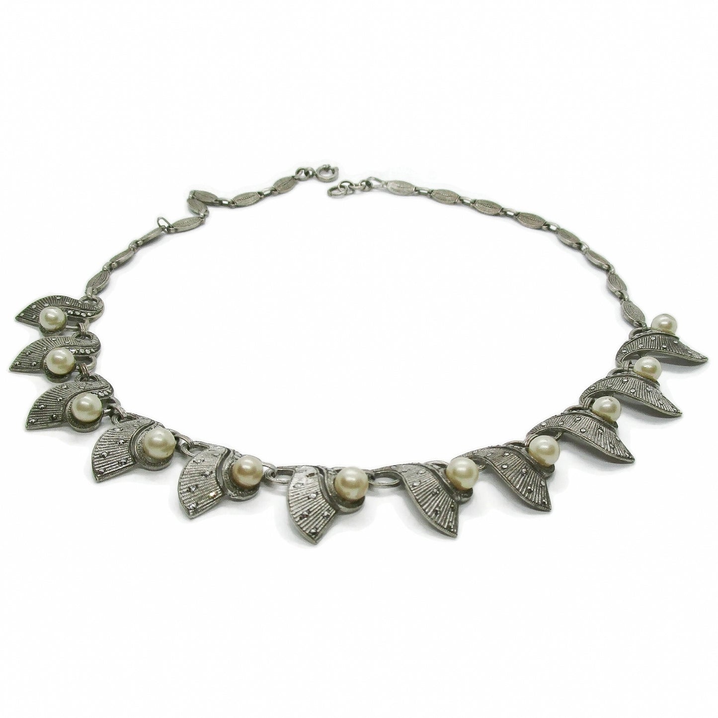 A sterling silver, marcasite and pearl necklace by Theodor Fahrner Germany on an white background