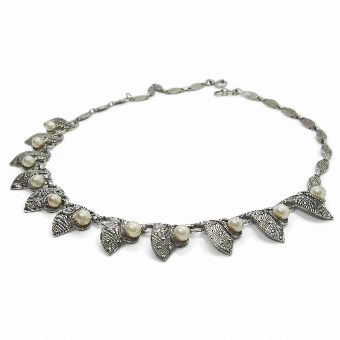 A Theodor Fahrner Germany sterling silver, marcasite and pearl necklace shown on an angle on a white background