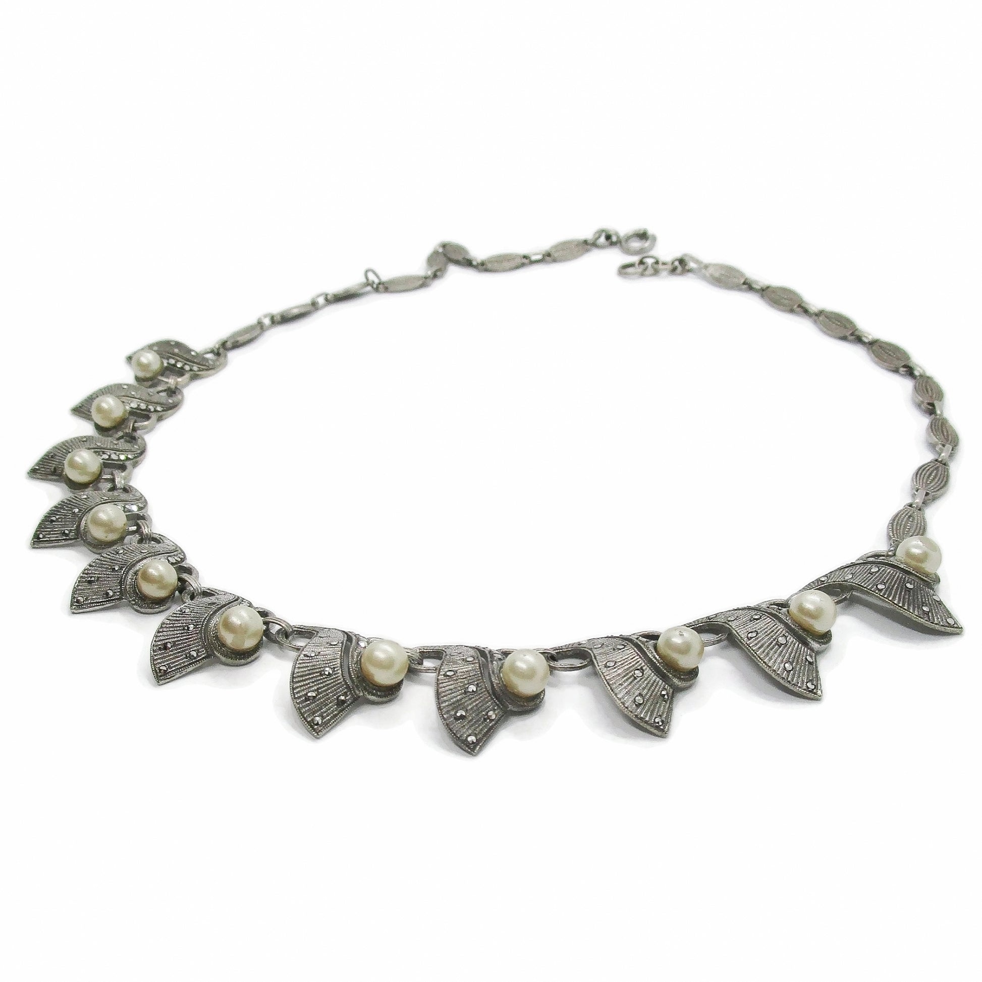 A Theodor Fahrner Germany sterling silver, marcasite and pearl necklace shown on an angle on a white background