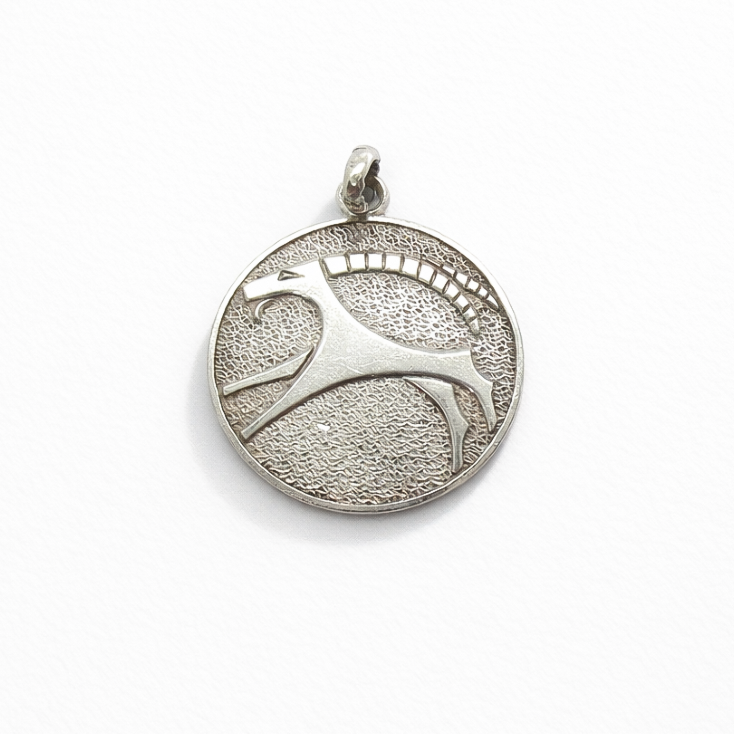 Front view of a modernist style Capricorn zodiac pendant in 835 silver