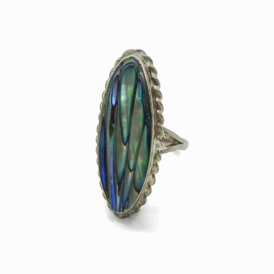 Angled view of an oval sterling silver and paua shell ring by Ataahua New Zealand