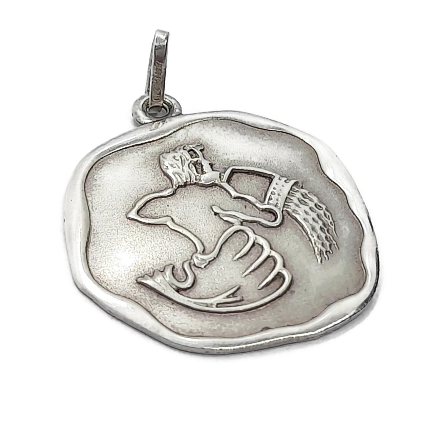 Angled view of a vintage sterling silver Aquarius pendant