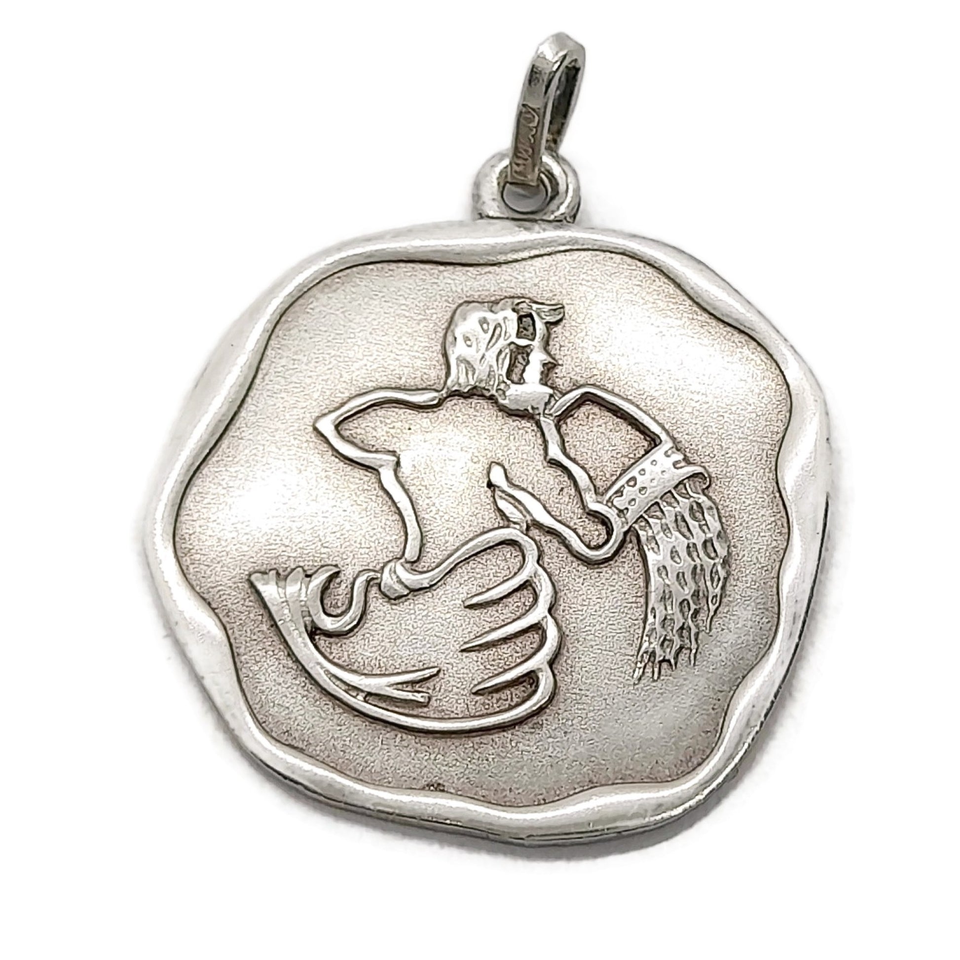 Front view of a vintage sterling silver Aquarius pendant