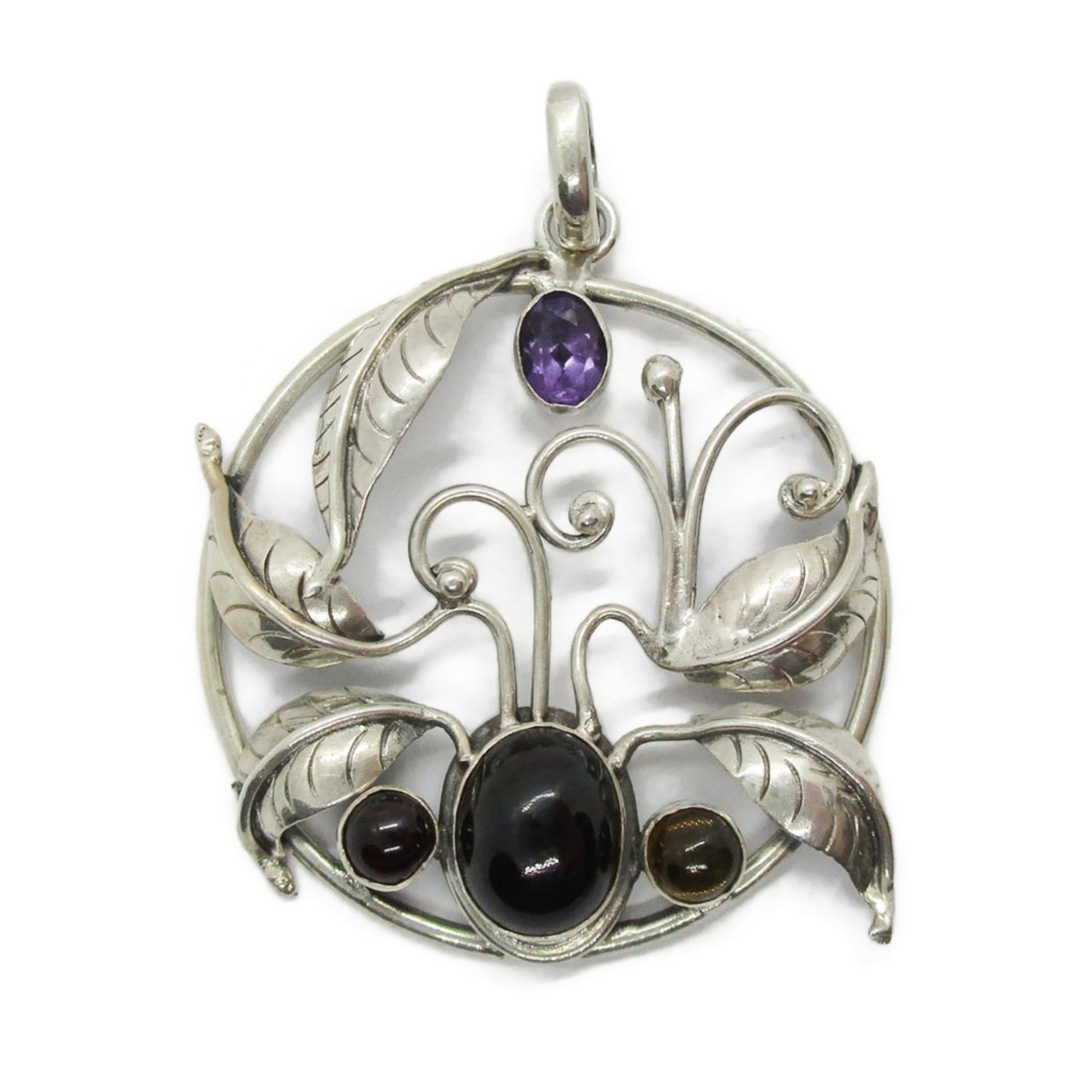 Front view of a large vintage sterling silver and gemstone floral design pendant