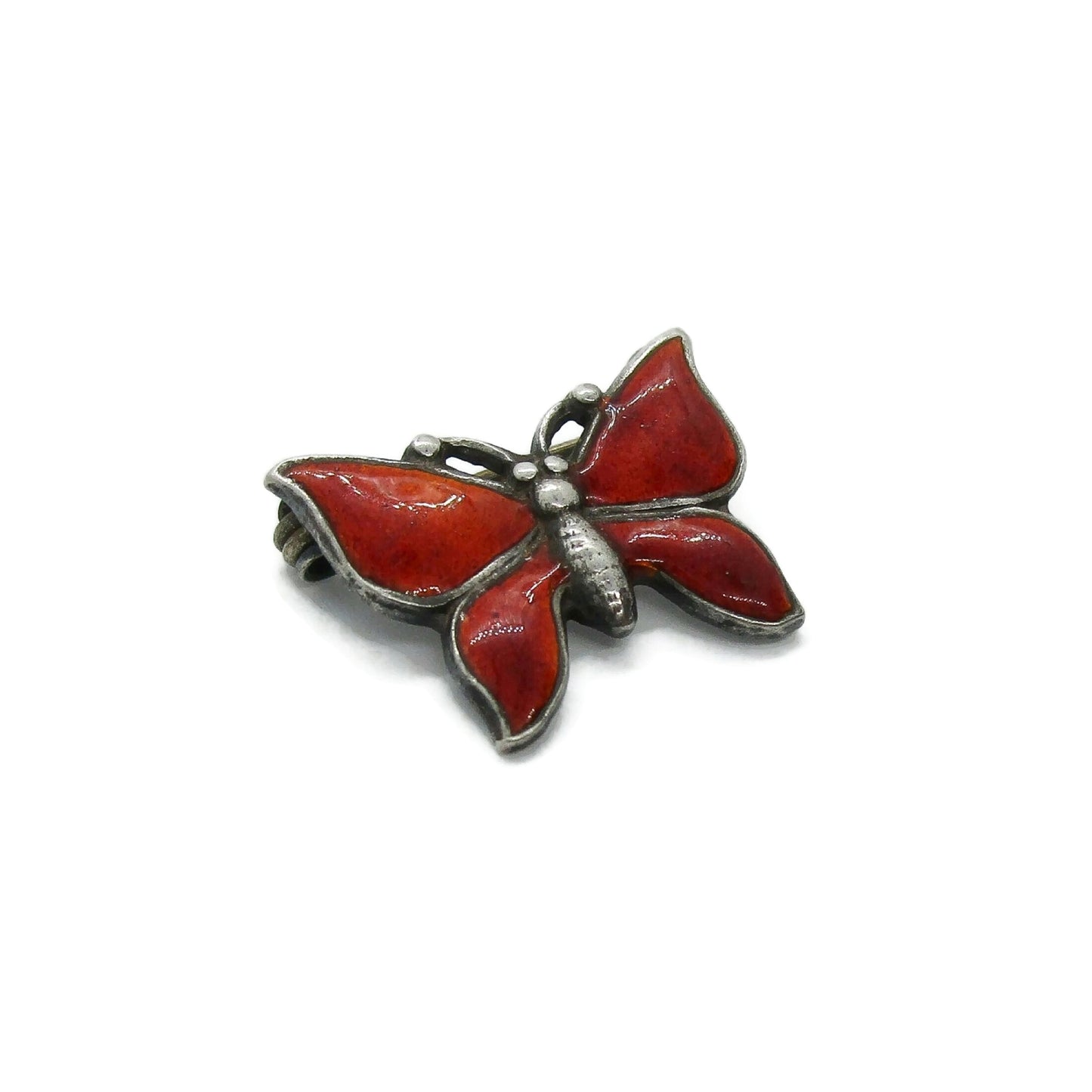 Small vintage red enamel sterling silver butterfly brooch seen from the side